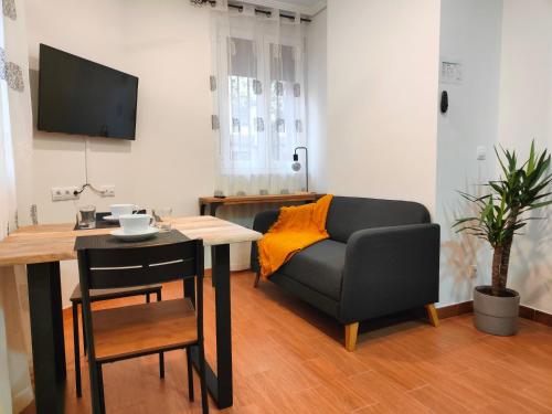a living room with a couch and a table at VuT La Casita del Cuéntame in Burgos