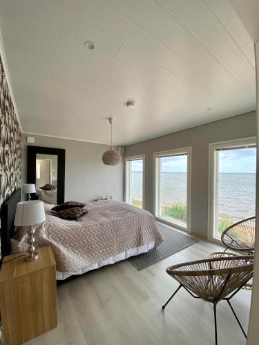 a bedroom with a bed and a view of the ocean at Beach House in Kalajoki