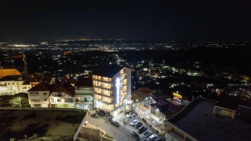 a lit up building in a city at night at Hotel Dior in Krujë