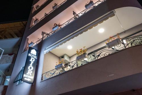 a balcony with potted plants on the side of a building at Hotel Dior in Krujë