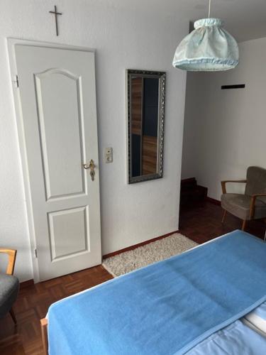 a room with a door and a cross on the wall at Gästehaus Elisabeth Bach in Mehring