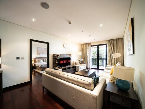 a living room with a couch and a table at Ultra Luxury Palm Stay - Full Sea & Burj View - Royal Amwaj in Dubai