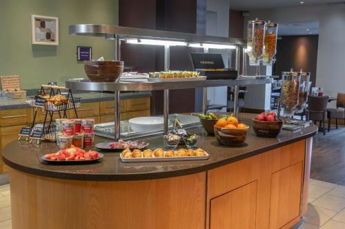 a buffet with food on a counter in a hotel at Milestone Peterborough Hotel A1M, Sure Hotel Collection by Best Western in Peterborough
