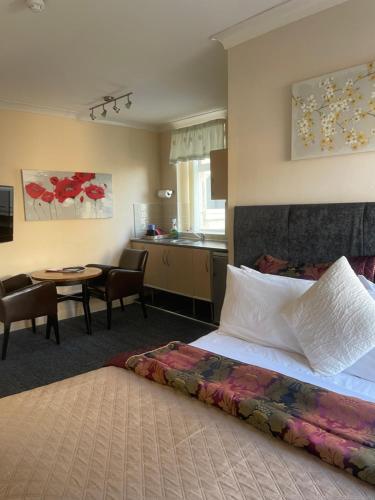 a hotel room with a bed and a table at Aparthotel Blackpool in Blackpool