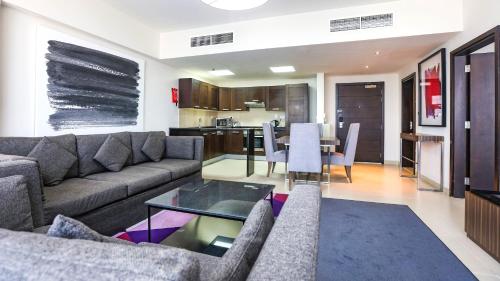 a living room with a couch and a table at Nassima Tower Hotel Apartments in Dubai