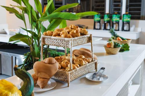 a table topped with a basket filled with bread at Cotton Bay Resort & Spa in Rodrigues Island