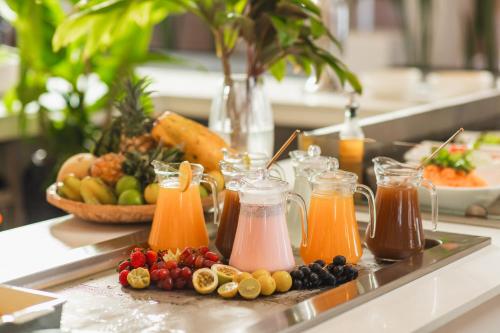 a tray of juice and fruits on a table at Cotton Bay Resort & Spa in Rodrigues Island