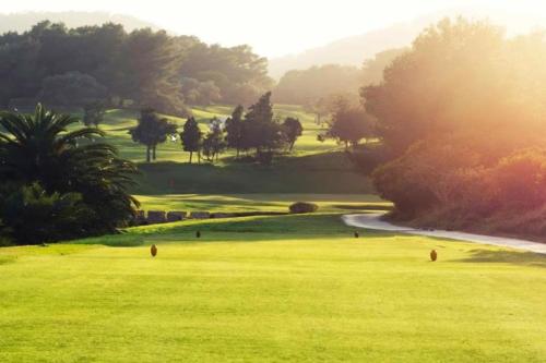 a golf course with a green field and trees at 7 Bedroom Villa with Pool - 5mins walk to Cala Llonga Beach - Can Ramon in Cala Llonga