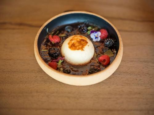 a bowl of cereal with berries and a marshmallow at Asty Mykonos Hotel & Spa - World of One Hotel Group in Mýkonos City