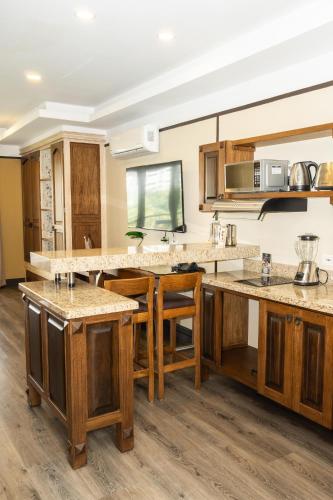 a kitchen with wooden counter tops and wooden cabinets at Hotel Du Parc in Medellín