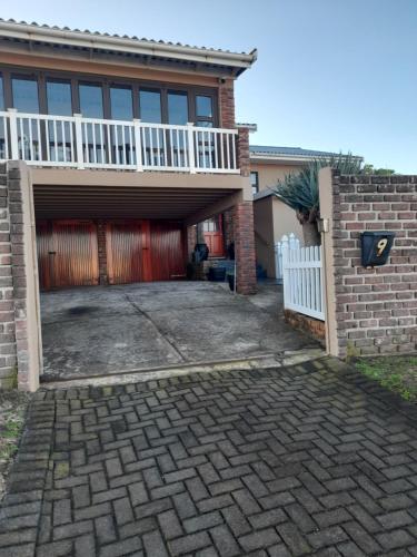 a house with a garage and a white fence at Breakers Edge in Bay View