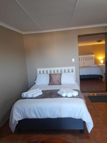 a bedroom with a large bed with two towels on it at Breakers Edge in Bay View