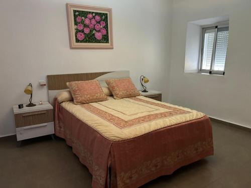 1 dormitorio con 1 cama con 2 mesas y una ventana en Villa Irene, en Málaga