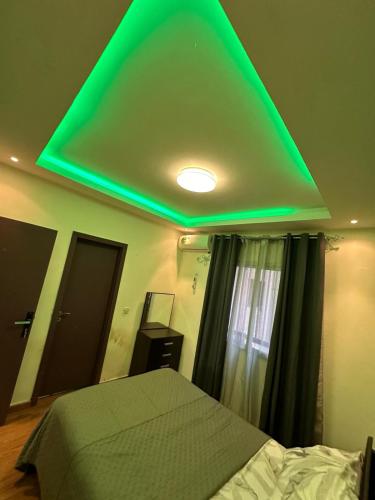 a green light on the ceiling of a bedroom at Appartement F4 situé à Coleah in Conakry
