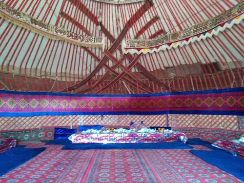 a room with two beds in a large tent at Ayazkala yurt camp in Bŭston