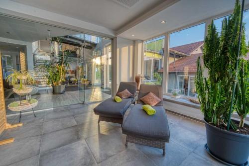 a living room with a couch and some plants at Hotel & SPA Reibener-Hof in Konzell