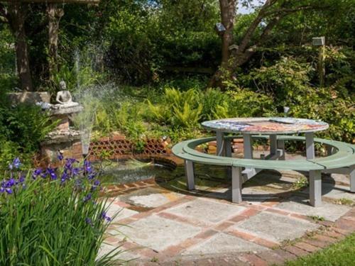 a picnic table in the middle of a garden at St Anne's in Glastonbury