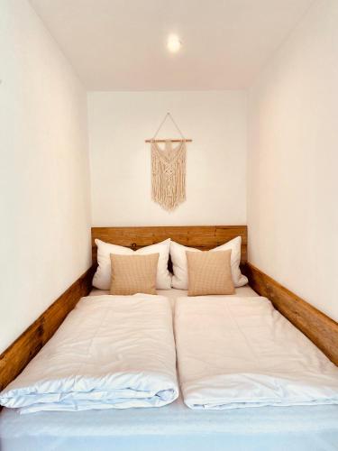 a bed in a room with two pillows at Luxury Mountain Lodge in Füssen