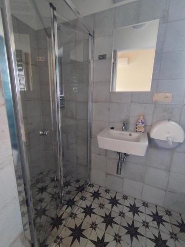 a bathroom with a shower and a sink at Resort Radslavice in Přerov