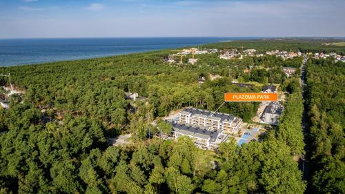 an aerial view of a house in a forest at Plażowa Park, Sun & Snow in Międzywodzie