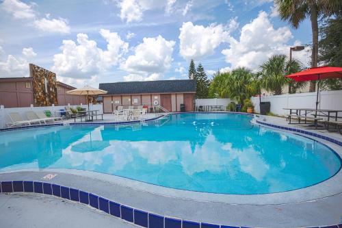 a large swimming pool with blue water at Liberty Inn and Suites Kissimmee near Disney World in Kissimmee