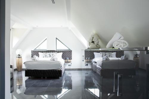 two beds in a room with black and white at Domaine de Bracheux Beauvais Chambre avec petit déjeuner inclus in Beauvais