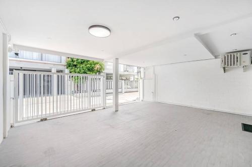 an empty room with white walls and a balcony at Haus Ekkamai 2 in Khlong Toei