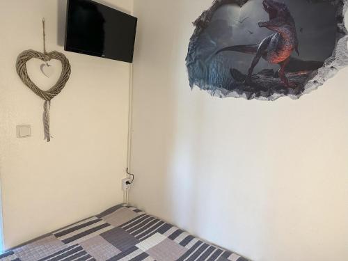 a bedroom with a bed with a heart hanging on the wall at Moderne und komfortable Appartements im Ferienpark Hahnenklee in Hahnenklee-Bockswiese