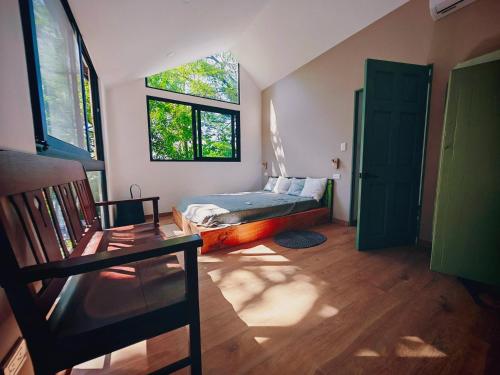 a bedroom with a bed and a window and a bed istg at Unique Tiny House-Best Beach in El Zonte in El Zonte