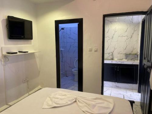 a bedroom with a bathroom with a toilet and a sink at Luxury TownHouse in Douala