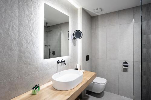 a bathroom with a sink and a toilet at Blue Star Luxury Hotel in Sofia