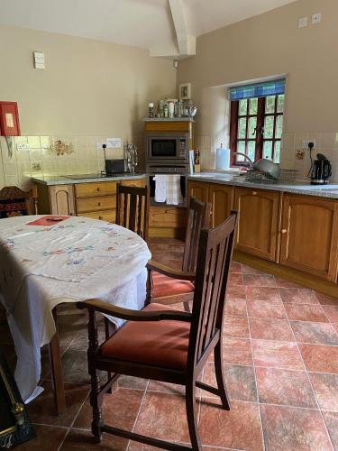 a kitchen with a table and chairs and a kitchen with a counter at Marnwood Lodge in Coalbrookdale