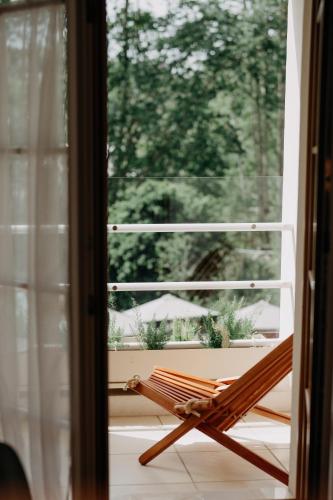 a wooden chair sitting in front of a window at Casa das Lérias in Amarante