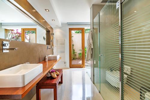 a bathroom with a sink and a shower at Can Lluc Boutique Country Hotel & Villas, a member of Beyond Green in Sant Rafael de Sa Creu