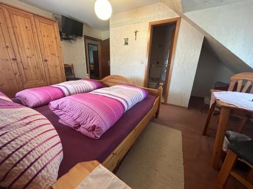 a room with four beds with pink pillows on them at Gasthaus Zur Krone in Langenfeld