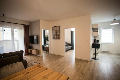 a living room with a couch and a table at Apartament Bellissima in Bielsko-Biala