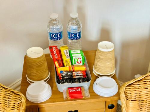 a table with two bottles of water and snacks at Le Papillon Hotel Blackpool in Blackpool