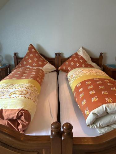 a bed with two pillows on top of it at Gasthaus Zur Krone in Langenfeld