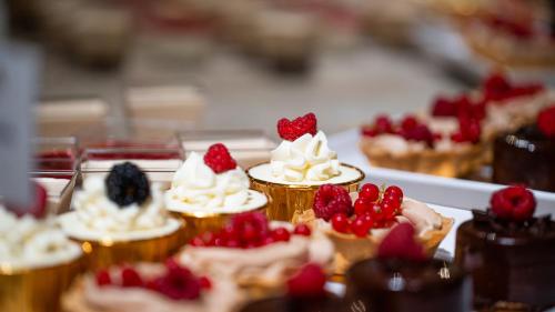 a group of cupcakes with strawberries and whipped cream at Instytut Zdrowia Sofra FIT & SPA in Mielno