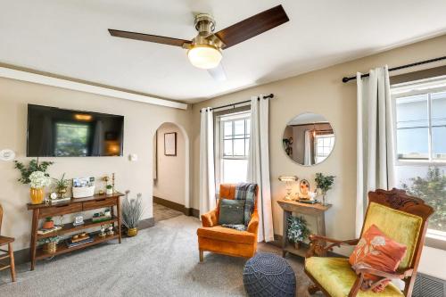 a living room with a ceiling fan and chairs at Historic Vacation Rental in Downtown Rapid City! in Rapid City