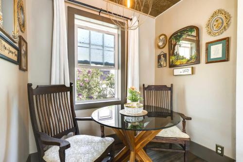 a dining room with a table and two chairs and a window at Historic Vacation Rental in Downtown Rapid City! in Rapid City