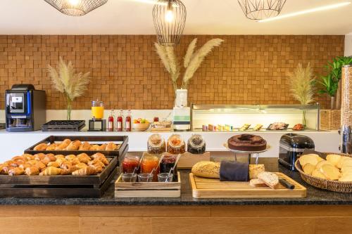 a bakery counter with various types of bread and pastries at Kyriad Chambéry Centre - Hôtel et Résidence in Chambéry