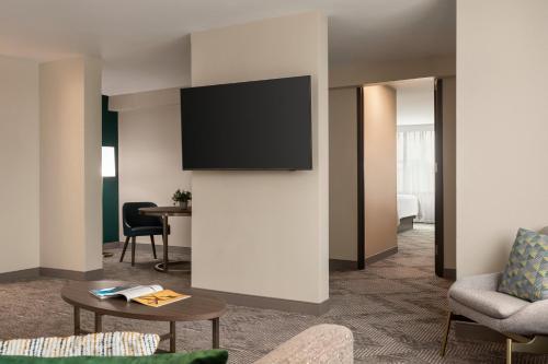 a living room with a flat screen tv on a wall at Holiday Inn Nashville Downtown - Stadium by IHG in Nashville