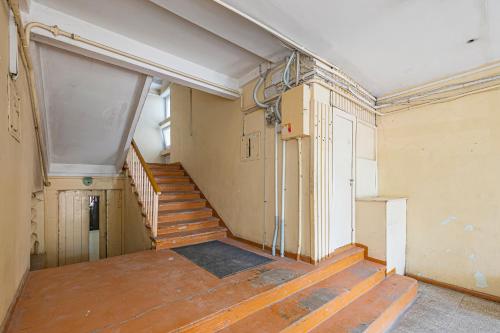 an empty room with a staircase in a building at Pramonės Apartment #11 by PoloApartments in Kaunas