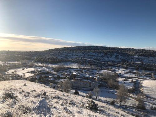 an aerial view of a town covered in snow at La cabaña del cañón in Vadillo