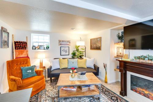 a living room with a couch and a fireplace at Centrally Located Apt Near Downtown Rapid City! in Rapid City