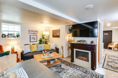 a living room with a couch and a fireplace at Centrally Located Apt Near Downtown Rapid City! in Rapid City