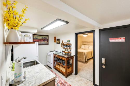 a kitchen with a sink and a refrigerator at Centrally Located Apt Near Downtown Rapid City! in Rapid City