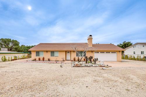 a house on a dirt lot with a driveway at Updated Abode 22 Mi to Joshua Tree National Park! in Morongo Valley