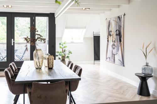 a dining room with a table and chairs at XXL Loft City center Villa Tilburg Willem 2 in Tilburg